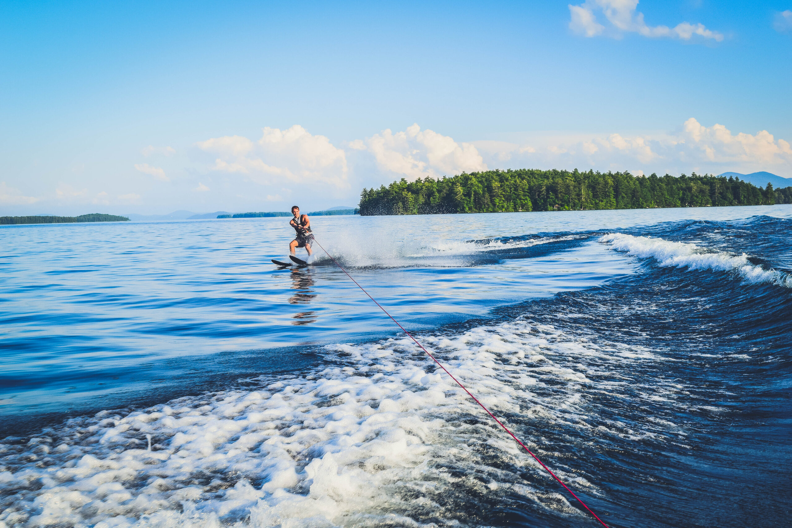 Lake Winnipesaukee_New Hampshire_Travel Guide_What to do_What to See_waterski_man_adventure_sport_water_nature_mountains