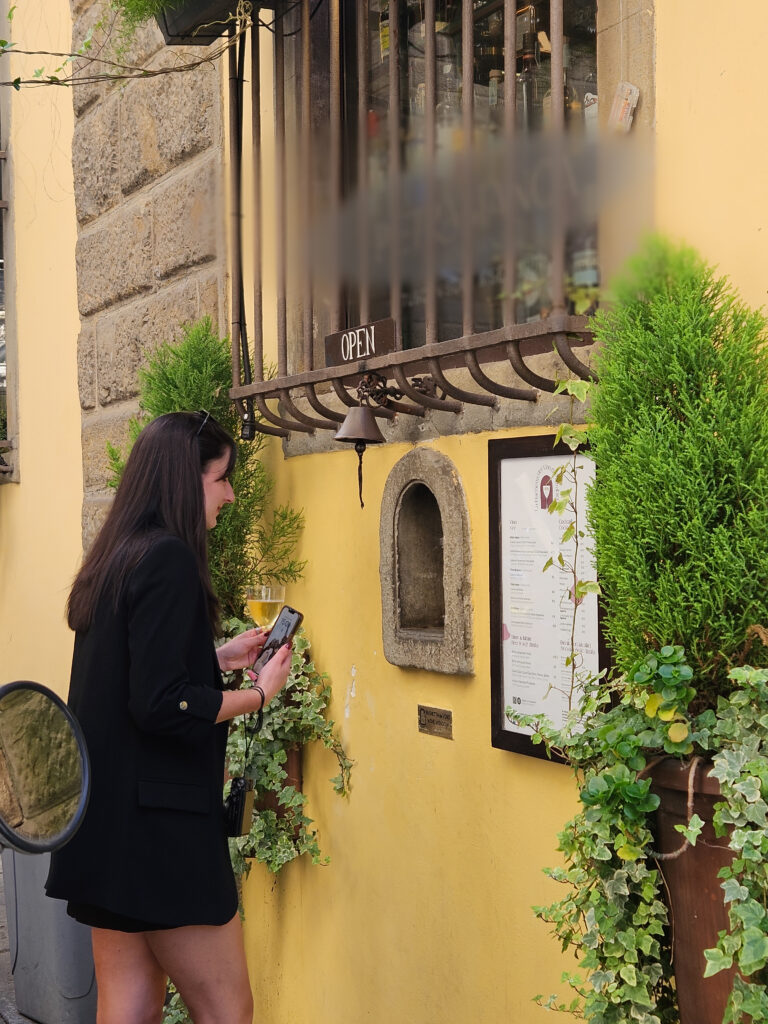 Local Florence travel tips: Drinking Chianti from a historic plague-era wine window.