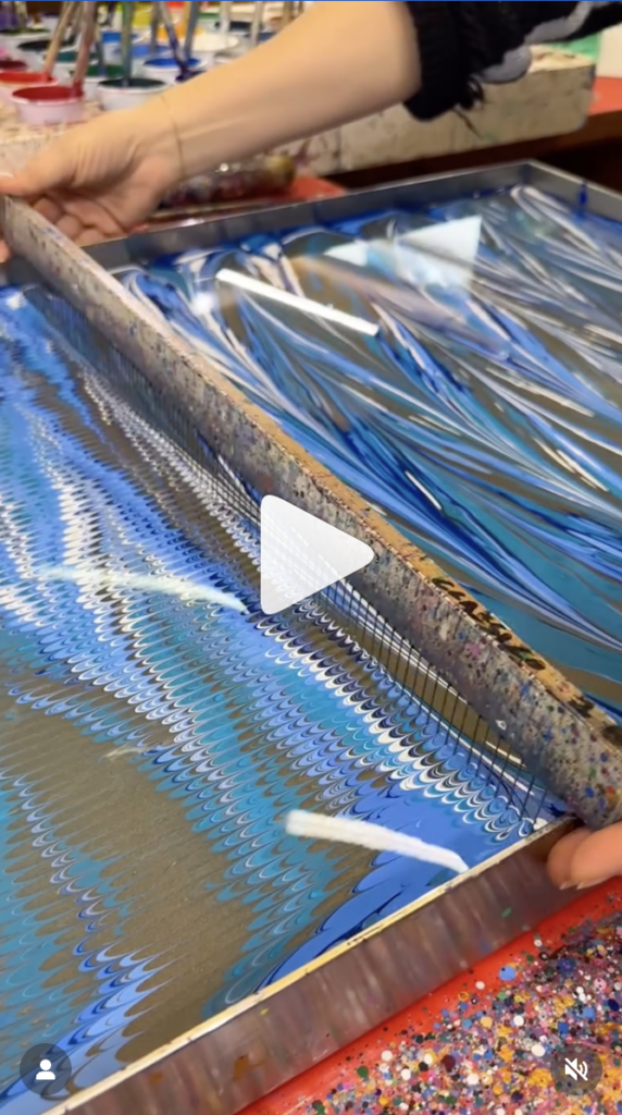 Artisan workshops in Florence: A master at A. Cozzi using traditional paper marbling techniques in the Oltrarno.