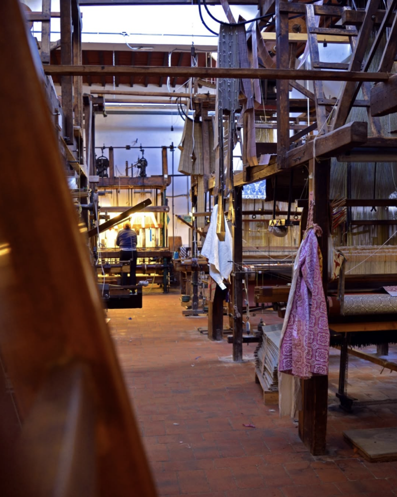 Traditional Florentine craftsmanship: Antique silk looms at Antico Setificio Fiorentino, an essential artisan workshop in Florence.