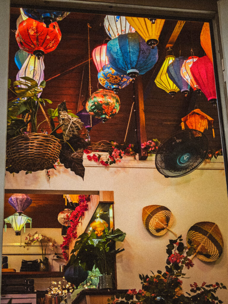 Bohemian interior of Nyama in Corossol featuring colorful Asian lanterns and greenery