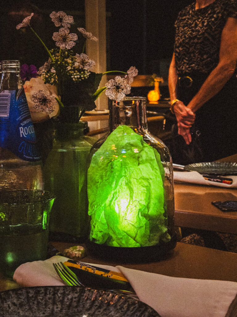 Whimsical table decor and bottle lights at an OG Corossol eatery