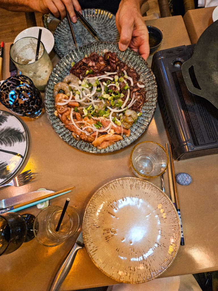 Interactive meat grill and spring roll experience at a local Corossol restaurant