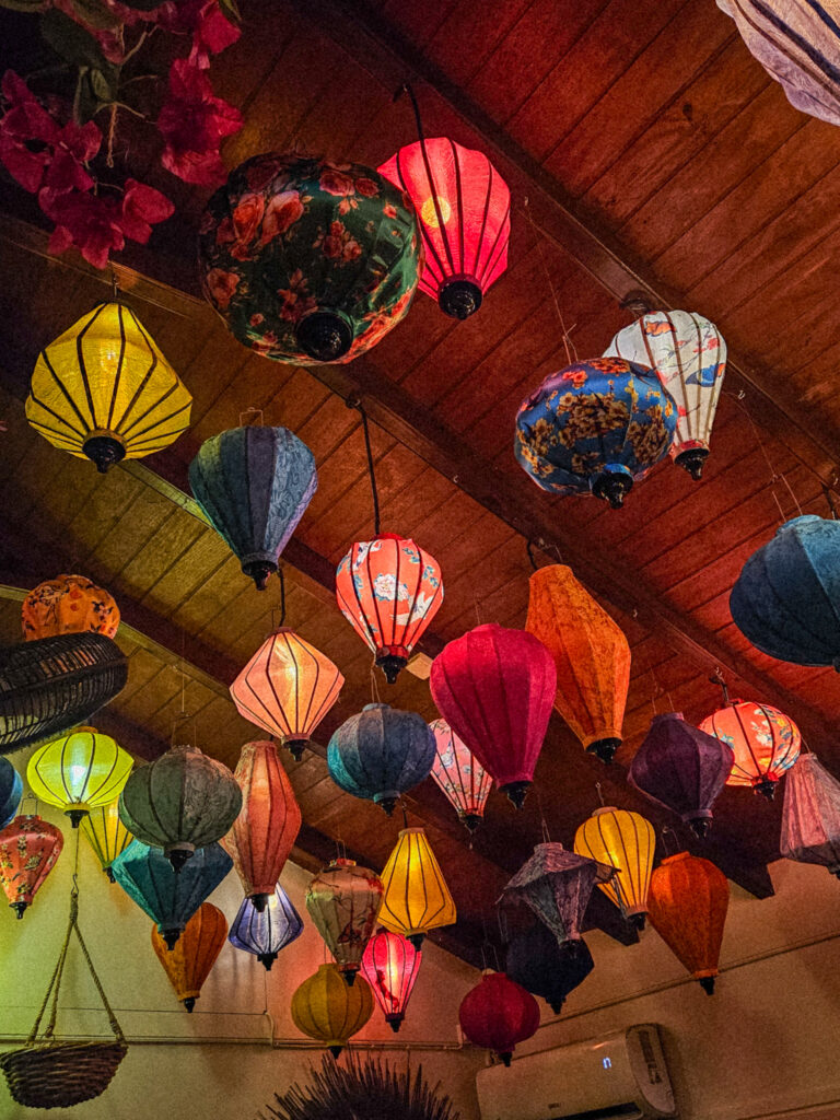 Bohemian interior of Nyama in Corossol featuring colorful Asian lanterns and greenery