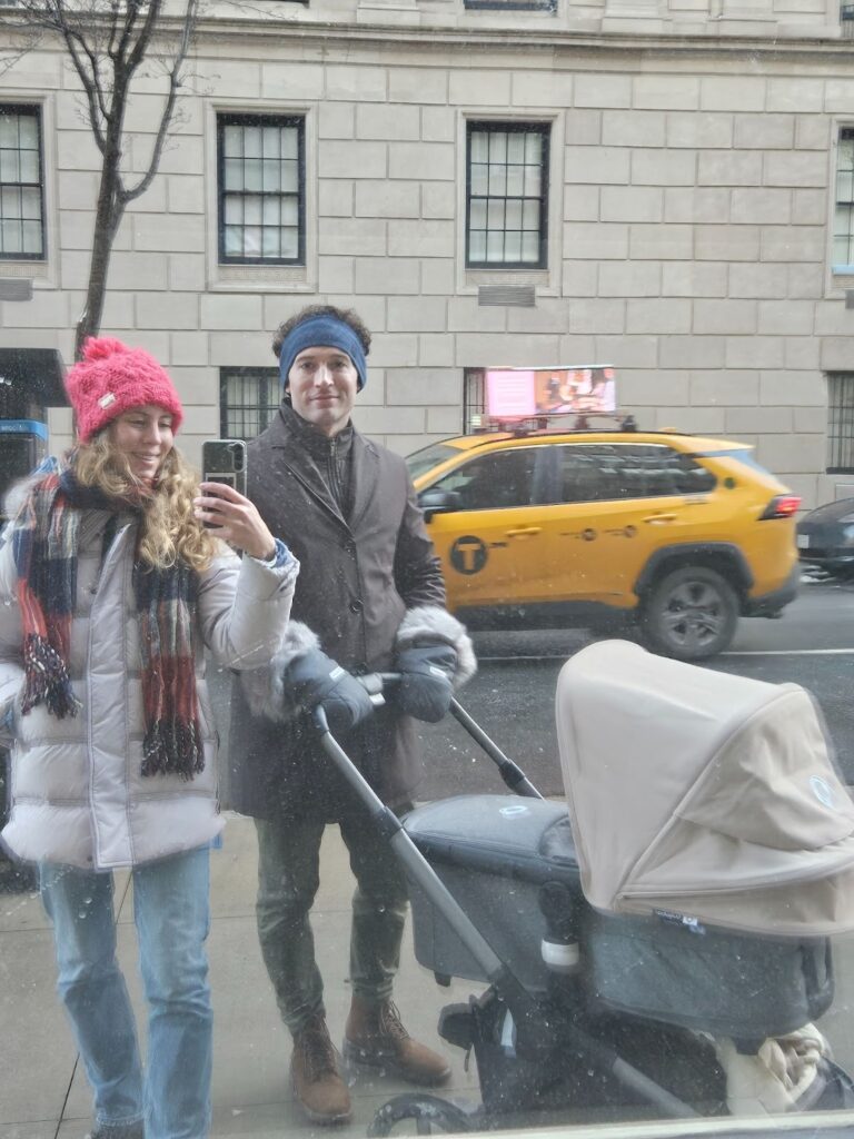 A view of a stroller in New York City near a Starbucks, a helpful USA travel tip for international visitors with kids.