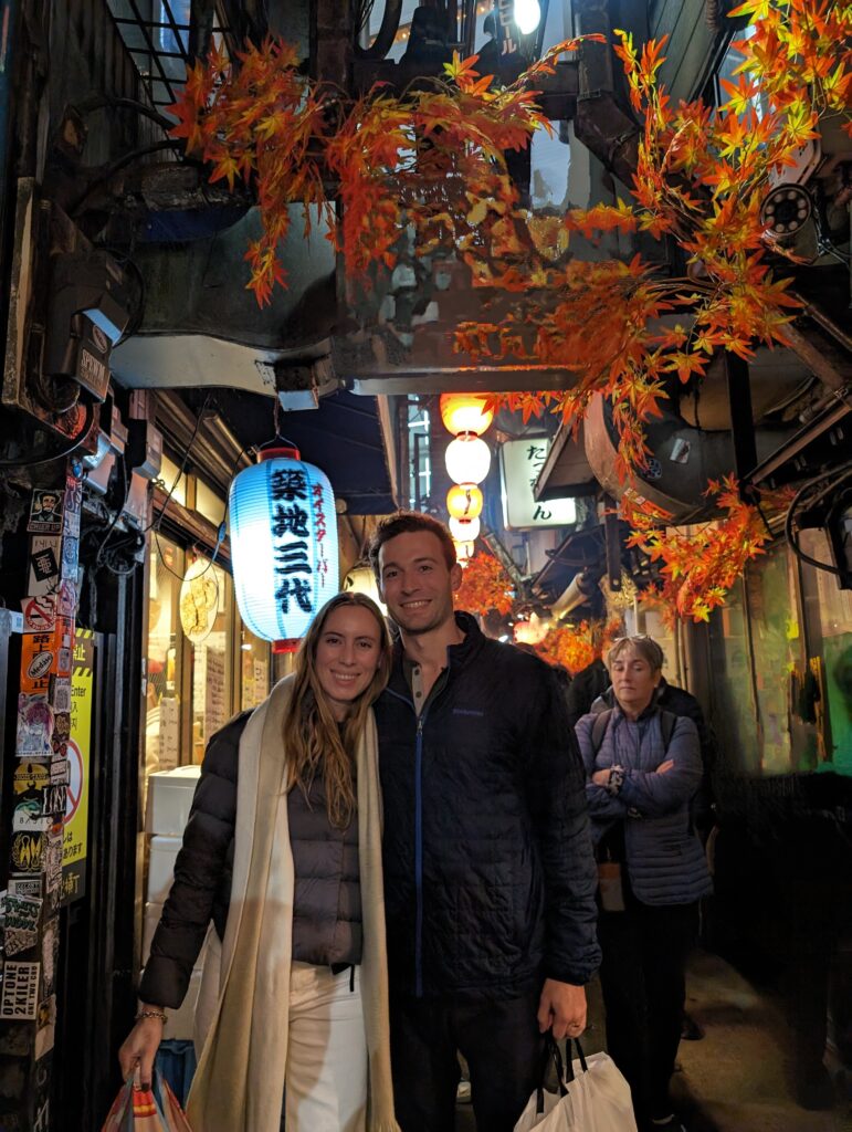 Smoky narrow stalls of Omoide Yokocho in Shinjuku, showing the 'Point and Eat' style of yakitori dining.